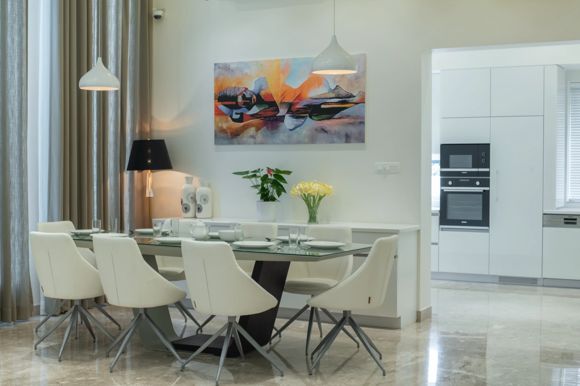 Bright dining space adjoining an open kitchen by Montimers